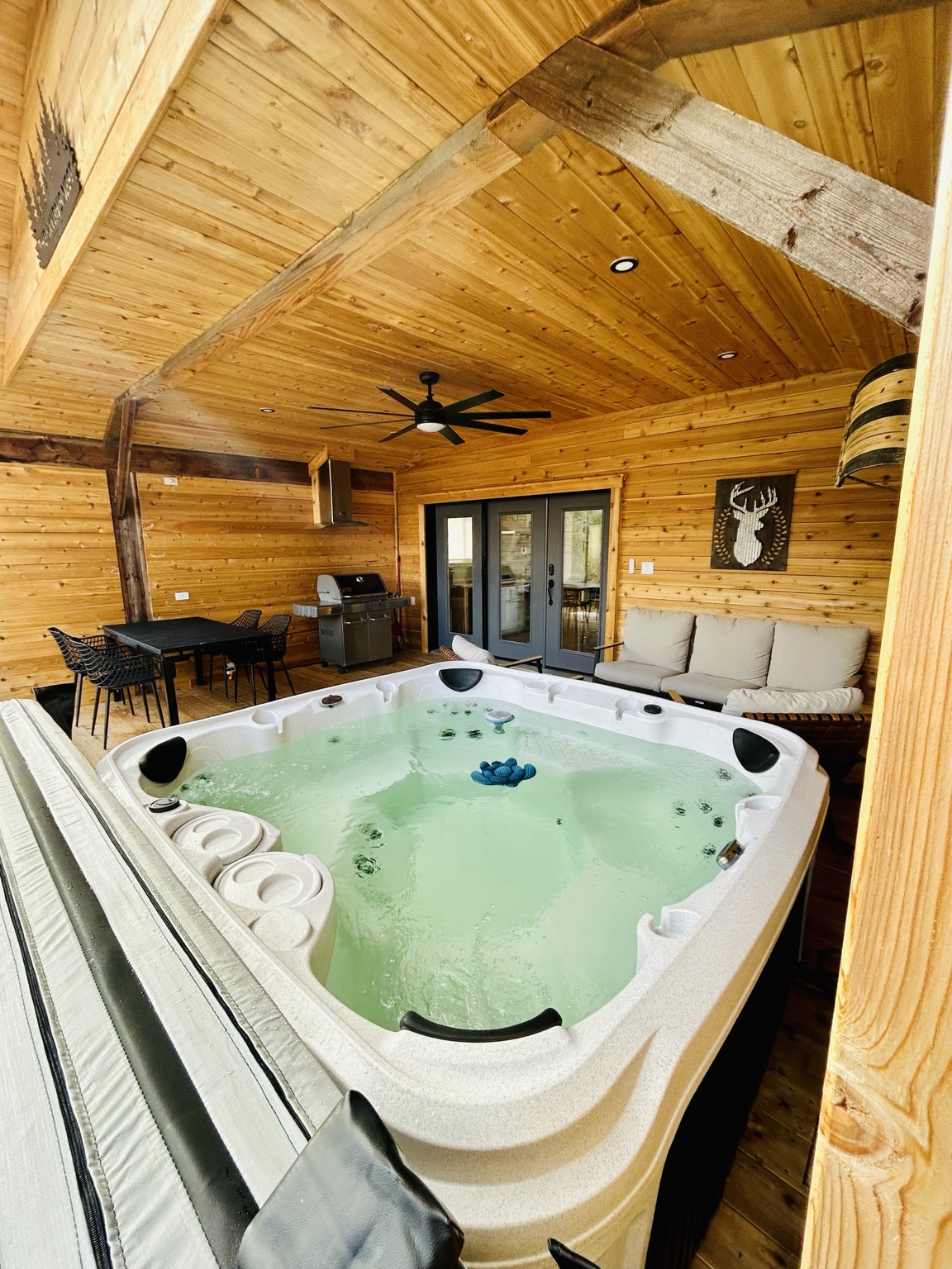 The private hot tub beneath the timber roof at Ravens Nest
